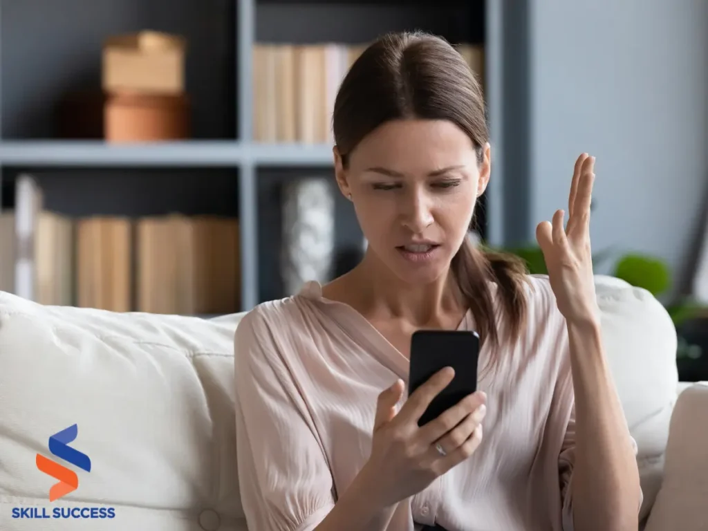 A woman on a couch engages with her phone, showcasing her skills in managing client relationships amid an angry customer situation