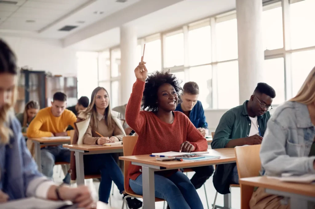 College Student Raising Hand Holding Pencil