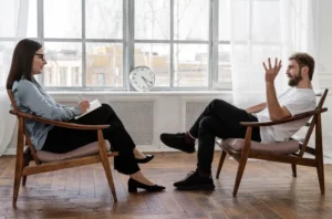 Psychologist Talking to Patient in Clinic