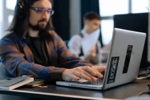 programmer building large language model llm on silver laptop