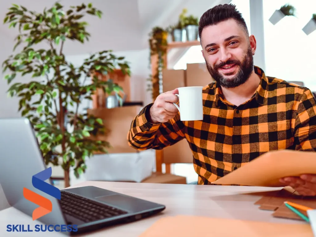 Smiling man with a cup of coffee after writing a two page cover letter