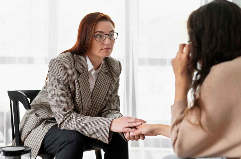 mental health professional holding patient's hand
