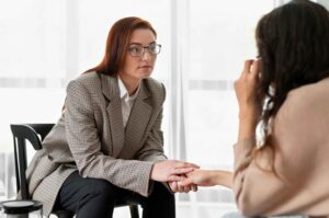 mental health professional holding patient's hand