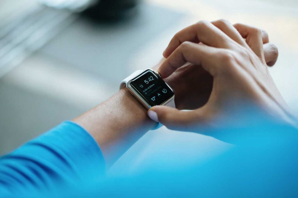 man looking at time on smart watch