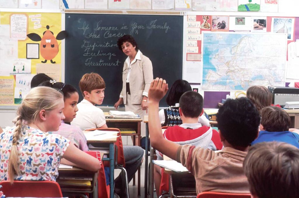teacher looking at student raising hand