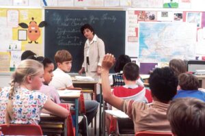 teacher looking at student raising hand