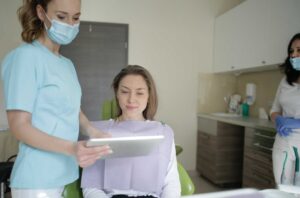 health educator wearing scrubs showing records to patient