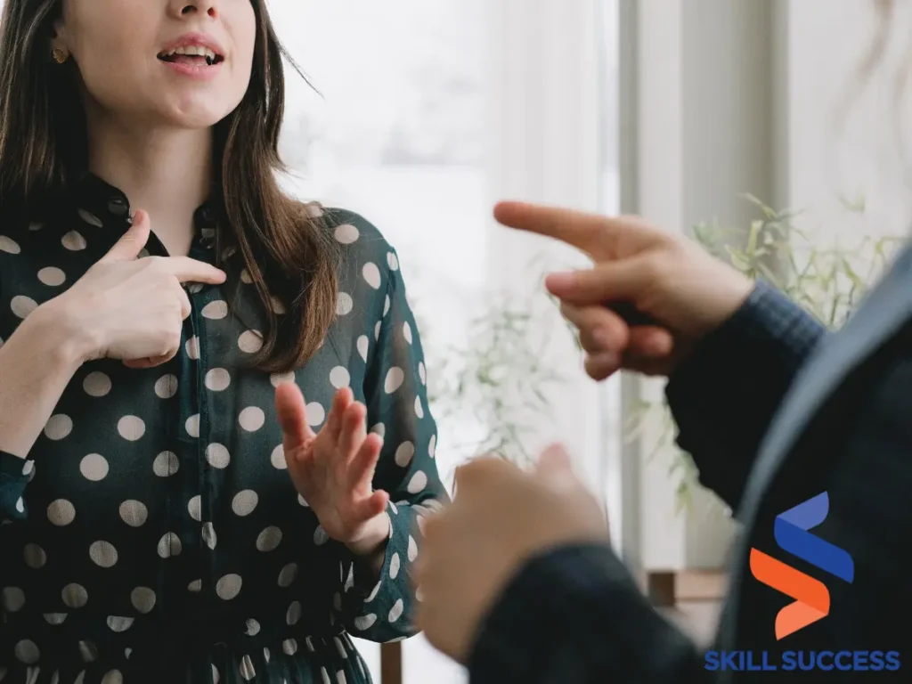 Two women discussing "how to talk to your boss" in front of a window, representing stages of conflict.