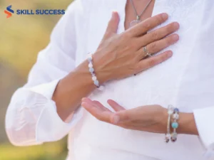 a woman placing her hands on her chest showing what she learned from the best chakra healing training course