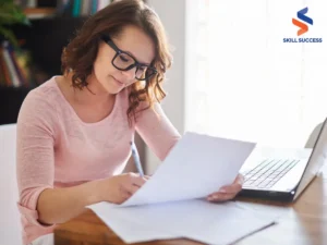 a woman writing on a piece of paper