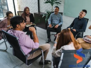 A diverse group of coworkers sitting in a circle, discussing how to promote diversity and inclusion in the workplace