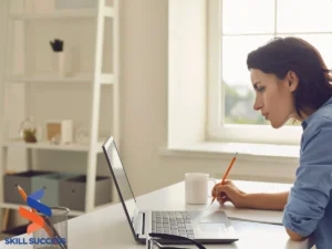 A woman at her desk with a laptop, focused on microlearning statistics for enhanced educational insights