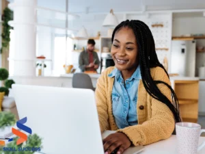 A woman focused on her laptop in a home office, engaging with microlearning courses for professional development