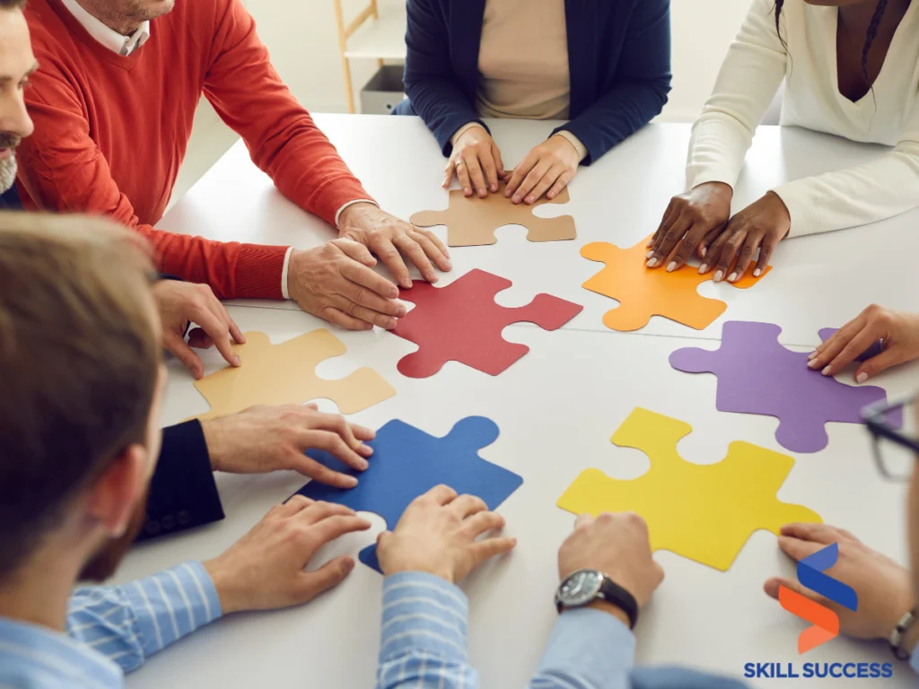 a small group of colleagues holding colorful puzzle pieces trying to put them all together