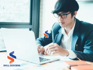a man looking for online courses on his laptop