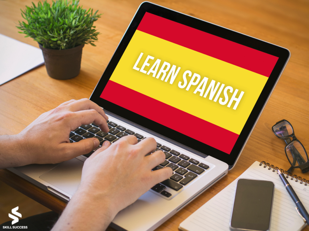 a laptop with "learn spanish" words on screen