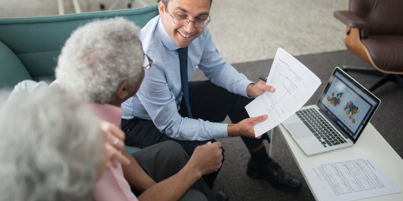 accountant showing documents to an elderly man