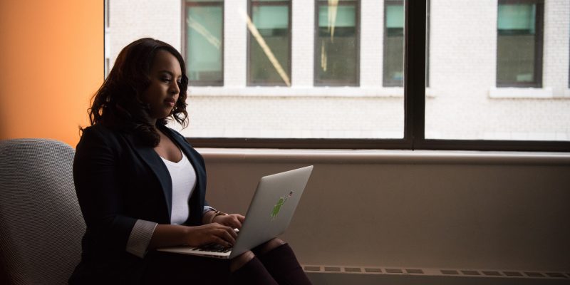 career woman working alone Career woman working alone on her laptop
