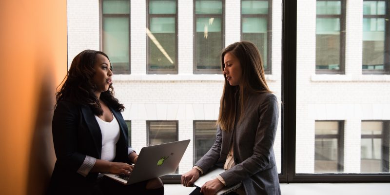 corporate women talking Two career ladies talking with each other
