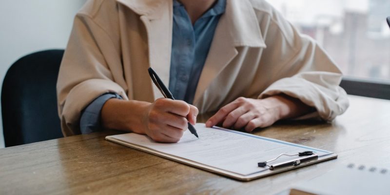 questions to ask second interview woman writing in clipboard job applicant writing on clipboard during second interview