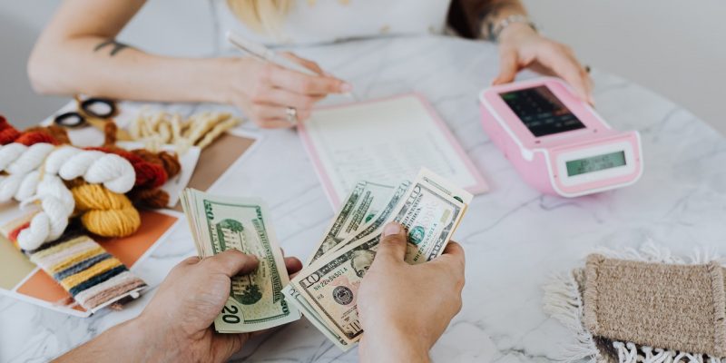 woman counting money to pay off debt woman counting money to pay off debt