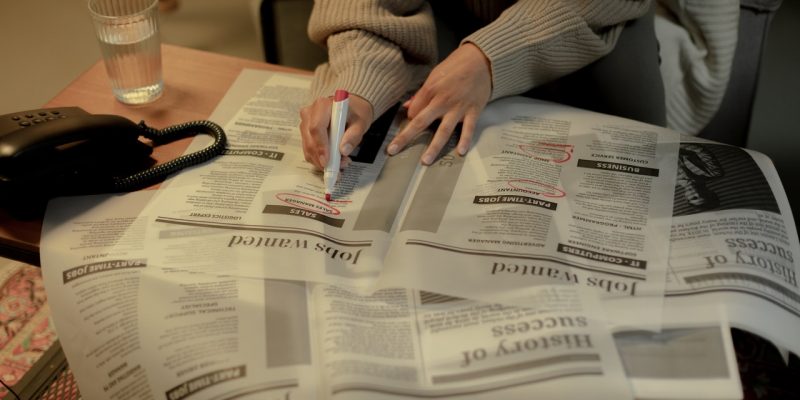 woman job search anxiety woman looking for jobs in news paper