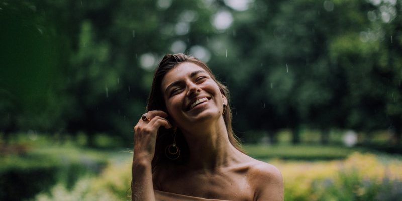 happy woman in off shoulder shirt smiling