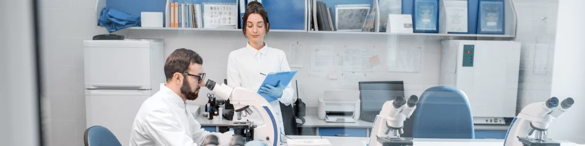 doctor-in-a-laboratory-office-with-medical-assistant-and-microscopes