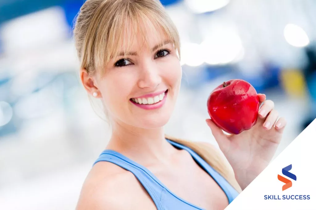 a-female-holding-an-apple-as-part-of-her-diet-recommended-by-a-dietitian-and-nutritionist