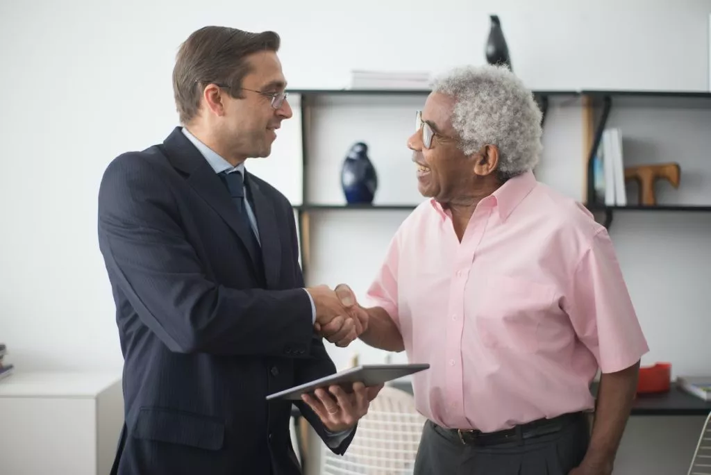insurance agent shaking hands with client