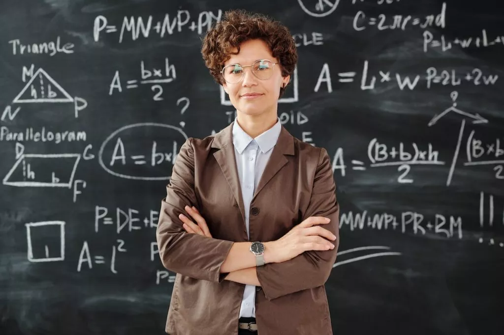 teacher with blackboard in the background