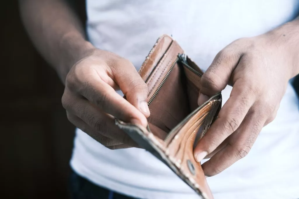 Person holding empty wallet financial problems