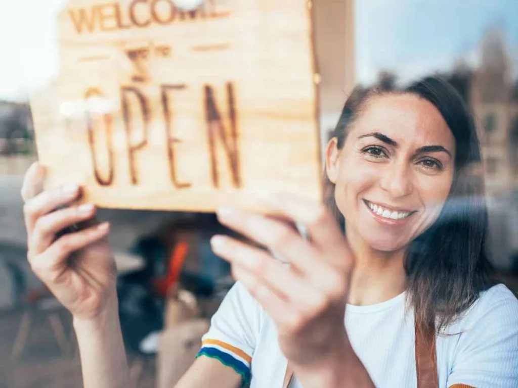 Small Business Owner Holding Open Sign