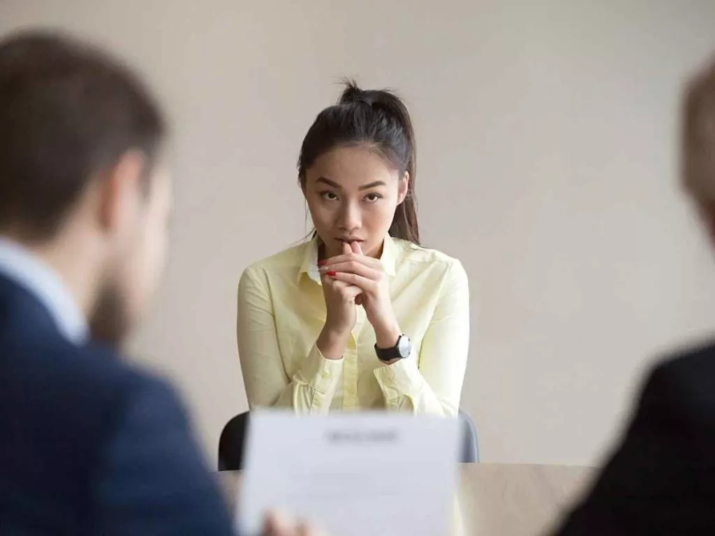 How to read body language in an interview anxious applicant in yellow top
