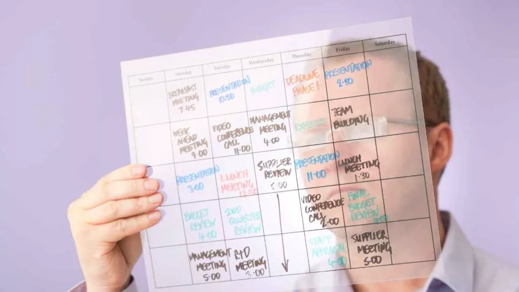 Work schedule man holding calendar