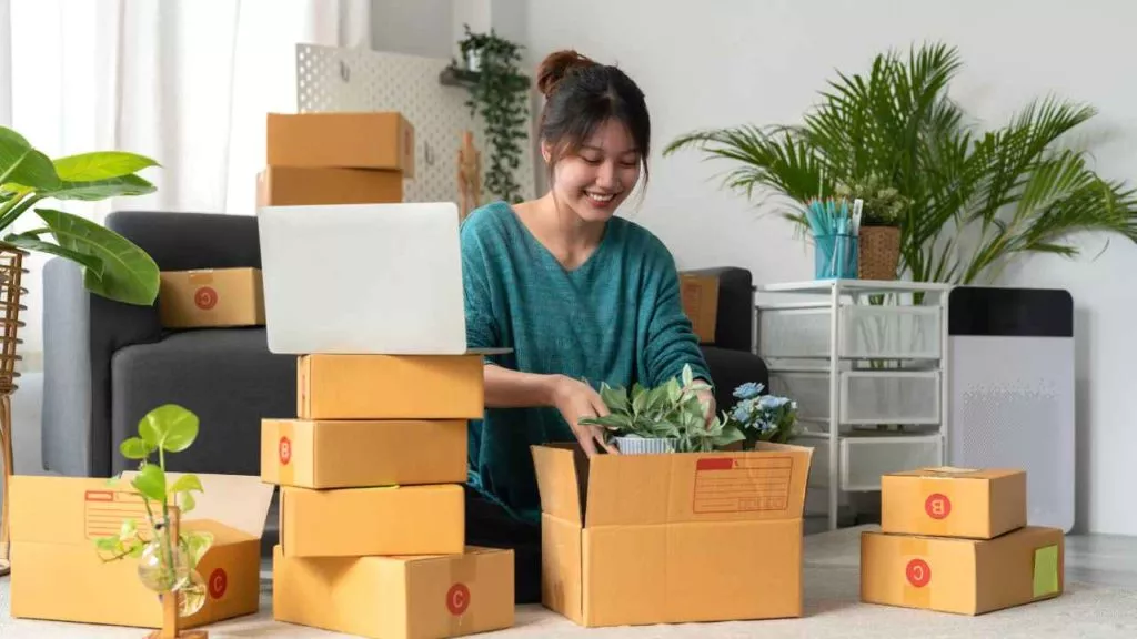Ecommerce Tools Female Business Owner Plants Boxes Shipping