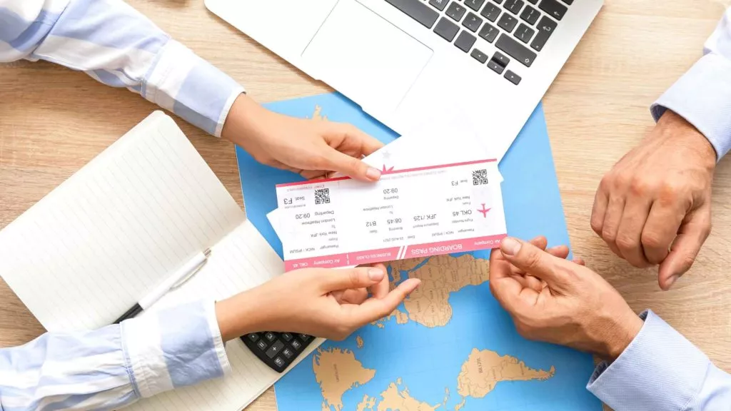 travel agent giving tickets to client
