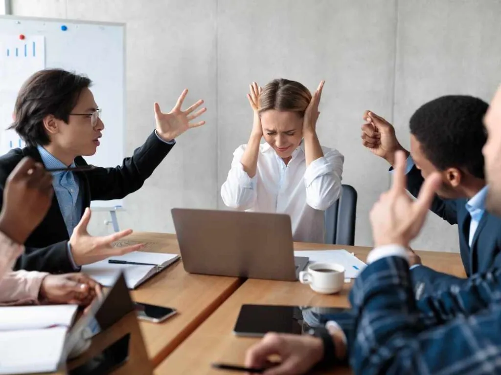 people in the workplace having conflict in meeting