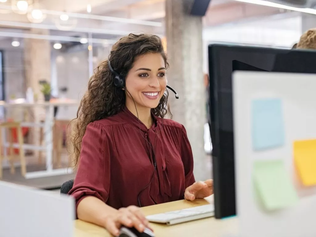 smiling woman working in call center