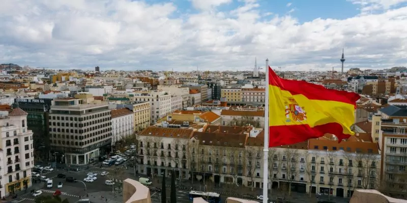 spanish national flag against cityscape