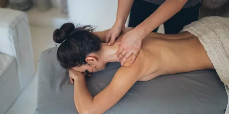woman lying on bed getting chinese massage