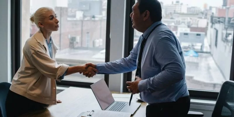 job applicant shaking hands with hiring manager after second interview