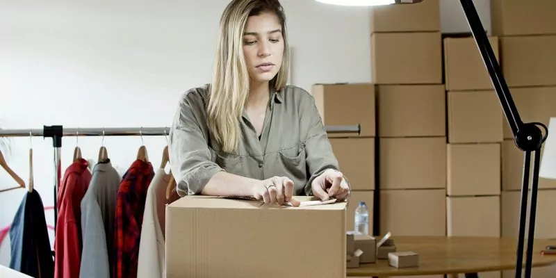 woman putting sticker on the box