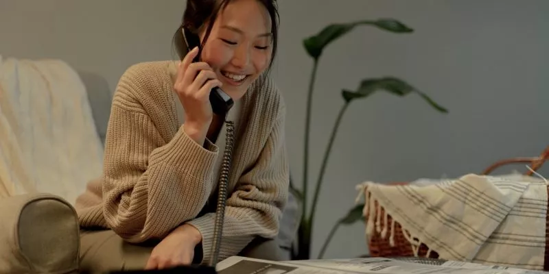woman overcoming job search anxiety smiling job seeker talking on phone
