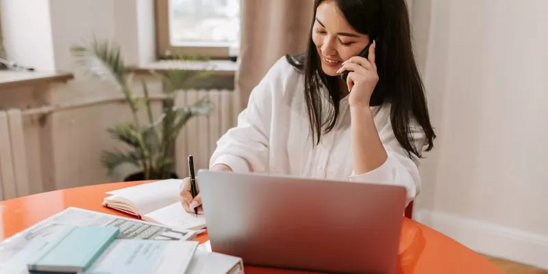 woman working remotely woman working remotely talking on phone